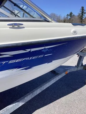 Slide: The Image of 2007 Bayliner HSP 190 boat on trailer, blue and white design, outdoors. - 4