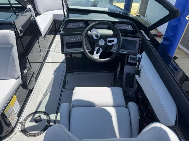 Slide: The Image of 2024 MasterCraft NXT23 boat interior with modern dashboard and steering wheel. - 13