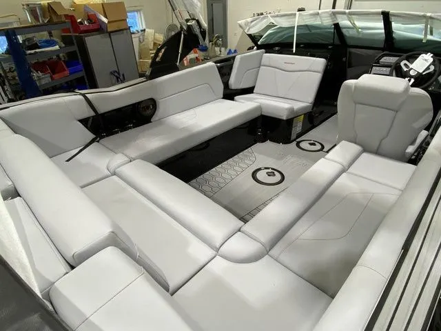Slide: The Image of 2024 MasterCraft NXT23 boat interior with spacious white seating and modern design. - 20