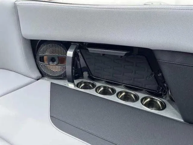 Slide: The Image of 2024 MasterCraft X24 interior with speaker and cup holders in sleek design. - 10