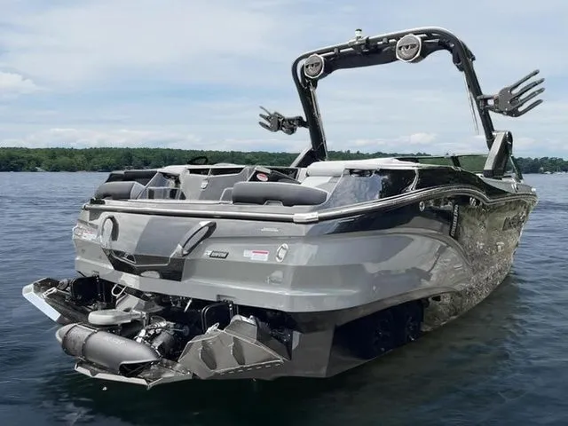 Slide: The Image of 2024 MasterCraft X24 boat on a lake, showcasing sleek design and advanced features. - 13