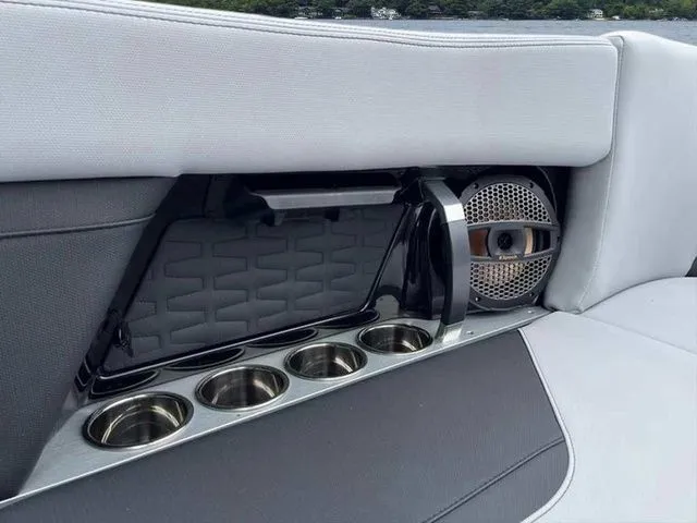 Slide: The Image of 2024 MasterCraft X24 boat interior with cup holders and speaker detail. - 16