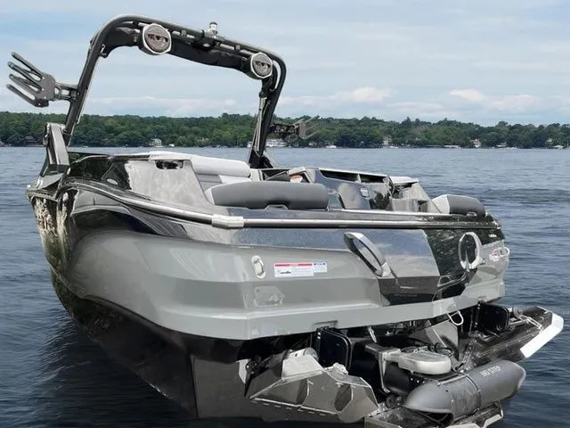 Slide: The Image of 2024 MasterCraft X24 boat on a lake, showcasing sleek design and advanced features. - 18