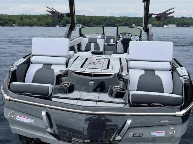 Slide: The Image of 2024 MasterCraft X24 boat with luxurious seating on a serene lake. - 22