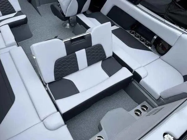 Slide: The Image of 2024 MasterCraft X24 boat interior with modern seating and cup holders. - 4