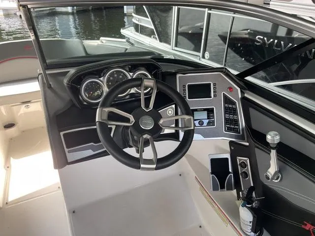 Slide: The Image of 2019 MasterCraft XT22 boat dashboard with steering wheel and control panel. - 10