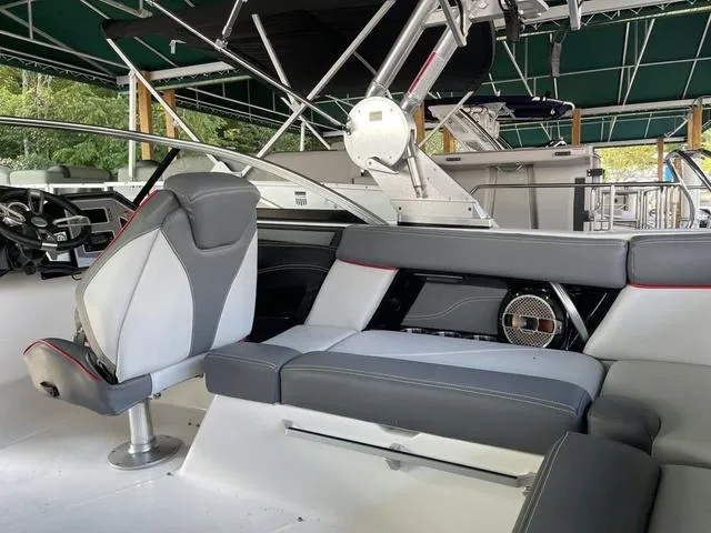 Slide: The Image of 2019 MasterCraft XT22 boat interior with gray seating and modern dashboard. - 9