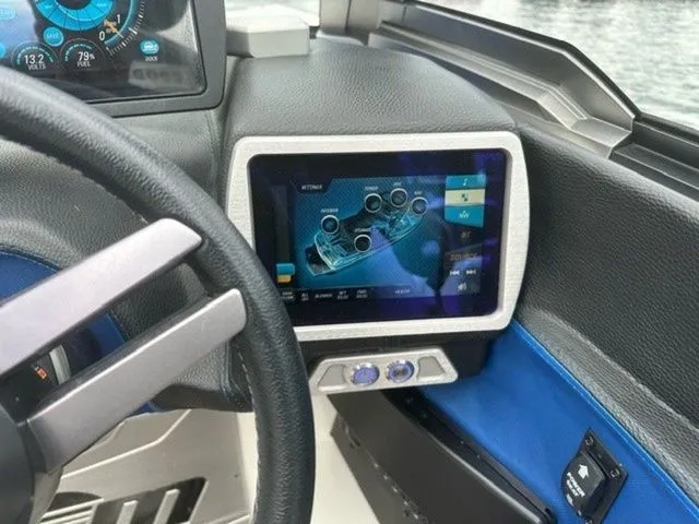 Slide: The Image of 2017 Malibu 24 MXZ dashboard with touchscreen display and steering wheel. - 10