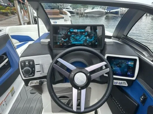 Slide: The Image of 2017 Malibu 24 MXZ boat dashboard with modern controls and digital displays. - 11