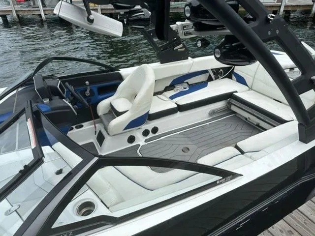 Slide: The Image of 2017 Malibu 24 MXZ boat interior with white seating and sleek design. - 6