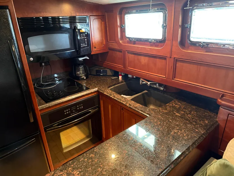 Slide: The Image of Luxurious kitchen interior of a 2009 custom Dutch canal barge with granite countertops. - 10