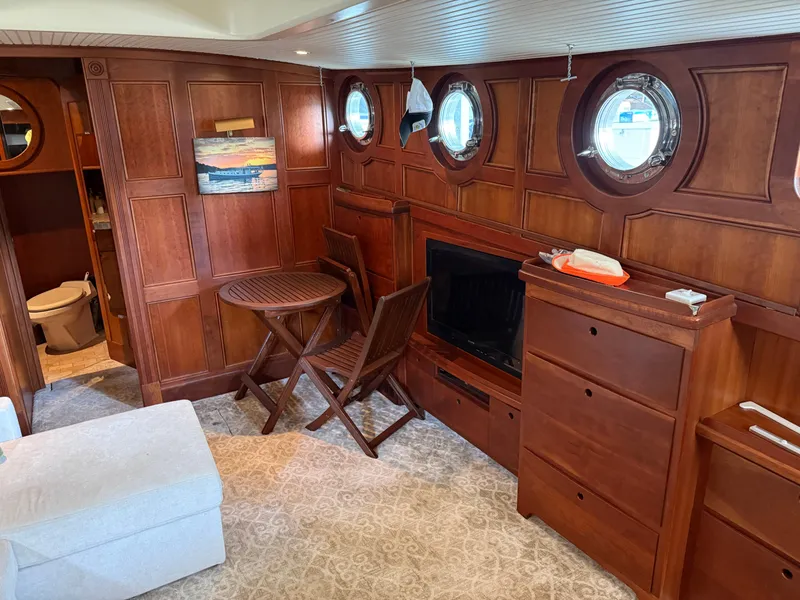 Slide: The Image of Luxurious interior of a 2009 custom Dutch canal barge with wood paneling and porthole windows. - 12