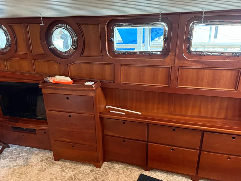 Slide: The Image of Interior of a 2009 custom Dutch canal barge with wooden cabinetry and porthole windows. - 13