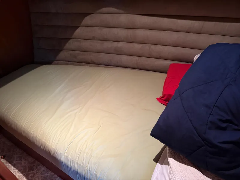 Slide: The Image of Single bed with red and blue pillows on a Dutch Canal Barge, 2009 model. - 17