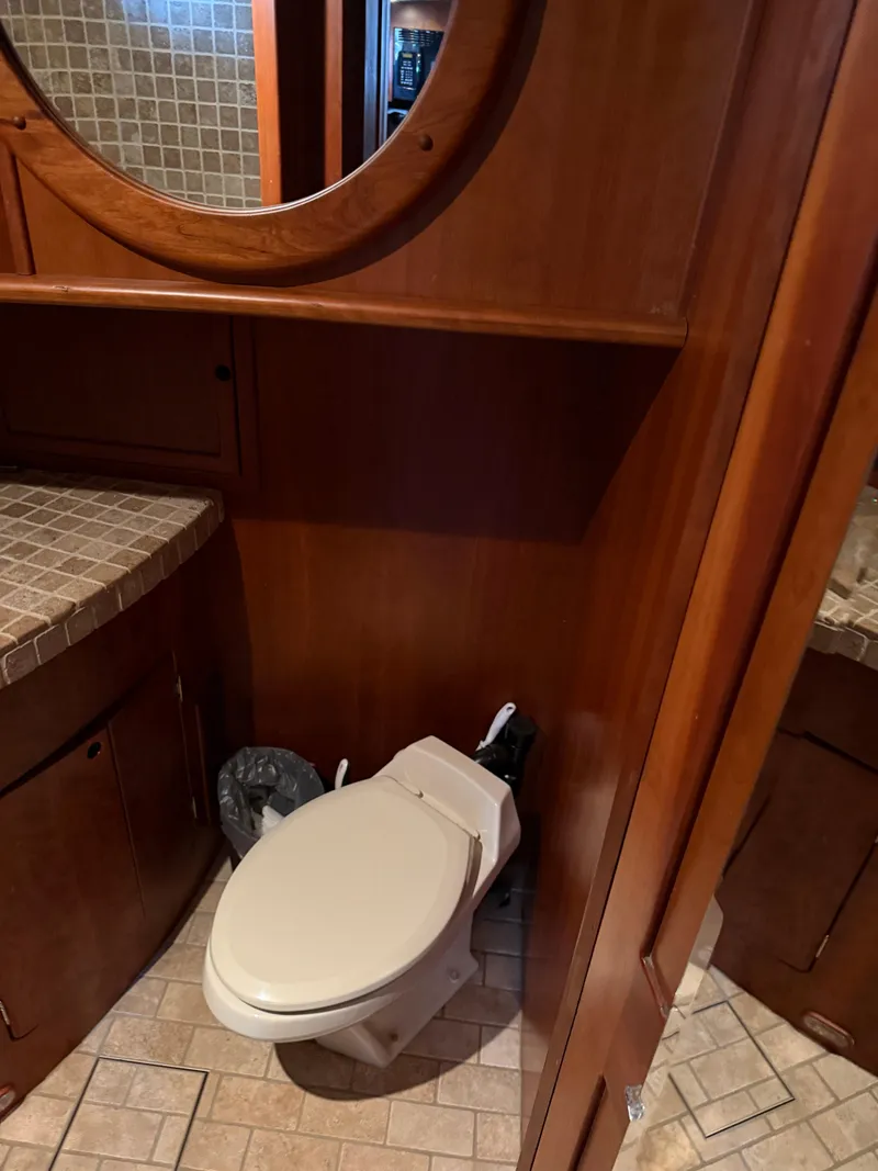 Slide: The Image of Compact bathroom on a 2009 Custom Dutch Canal Barge with wooden cabinetry and tiled surfaces. - 18