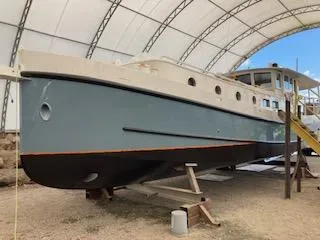 Slide: The Image of Custom 2009 Dutch Canal Barge under a large canopy, displayed on supports. - 2