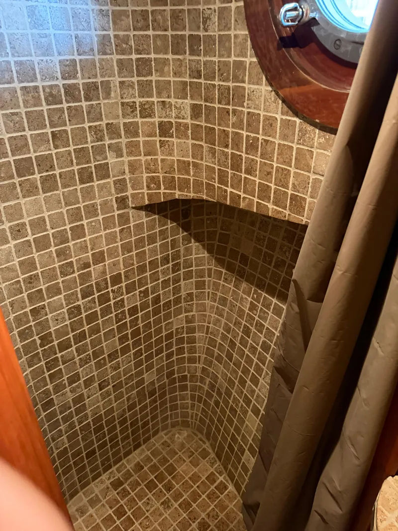 Slide: The Image of Tiled shower area in a 2009 Custom Dutch Canal Barge with porthole window. - 20