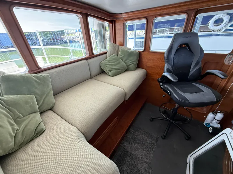Slide: The Image of Interior of a 2009 Custom Dutch Canal Barge with cozy seating and a swivel chair. - 7