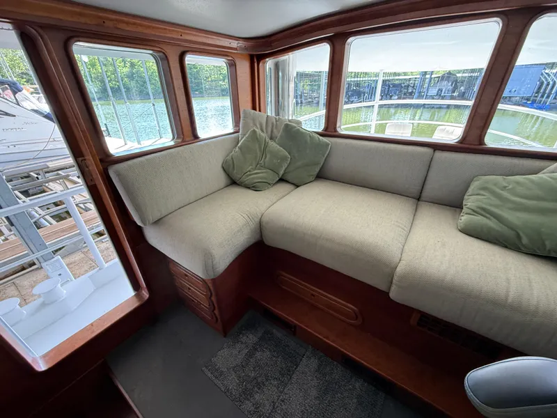 Slide: The Image of Cozy interior of a 2009 Custom Dutch Canal Barge with cushioned seating and large windows. - 8