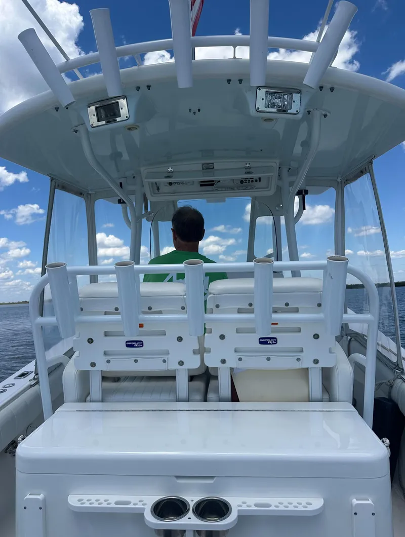 Slide: The Image of 2009 Regulator 32FS boat with dual seats, viewed from the rear on a sunny day. - 12