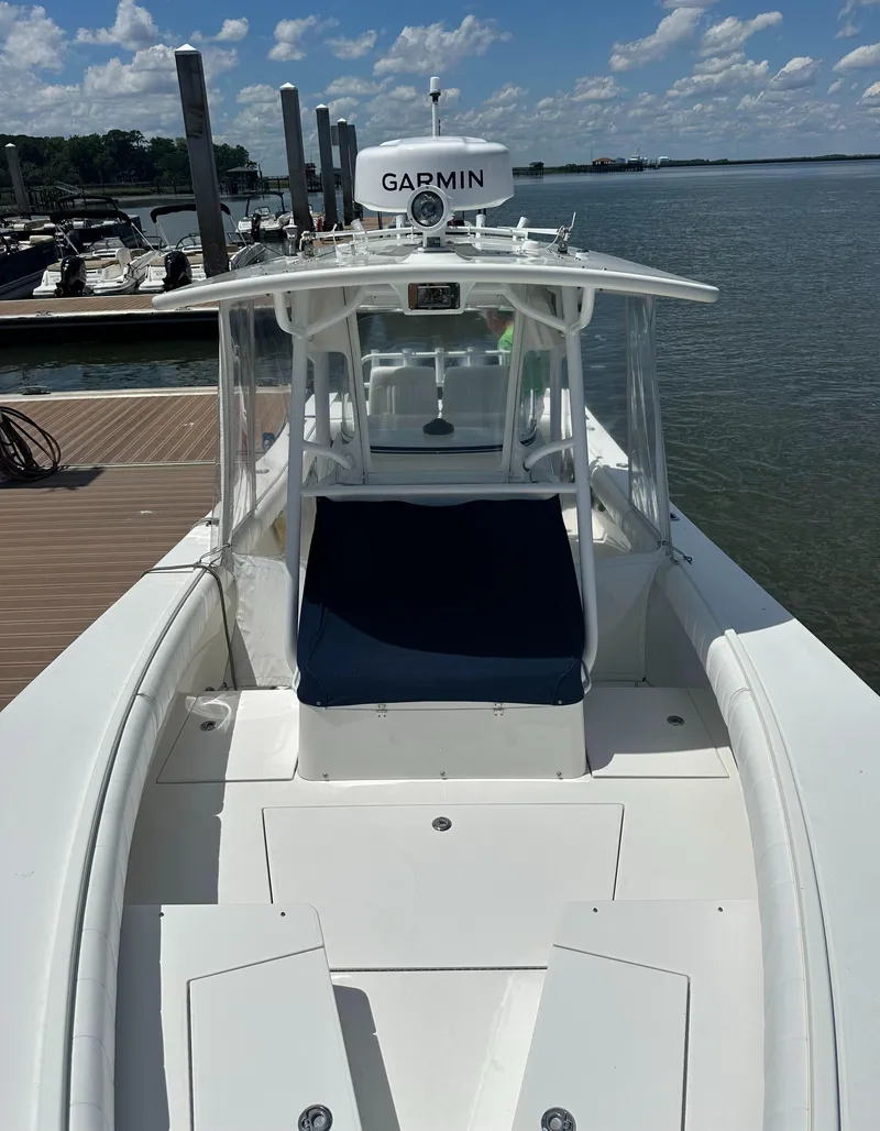 Slide: The Image of 2009 Regulator 32FS boat docked by the water under a clear blue sky. - 14