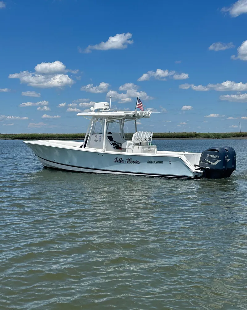 Slide: The Image of 2009 Regulator 32FS boat on calm water under a blue sky. - 16