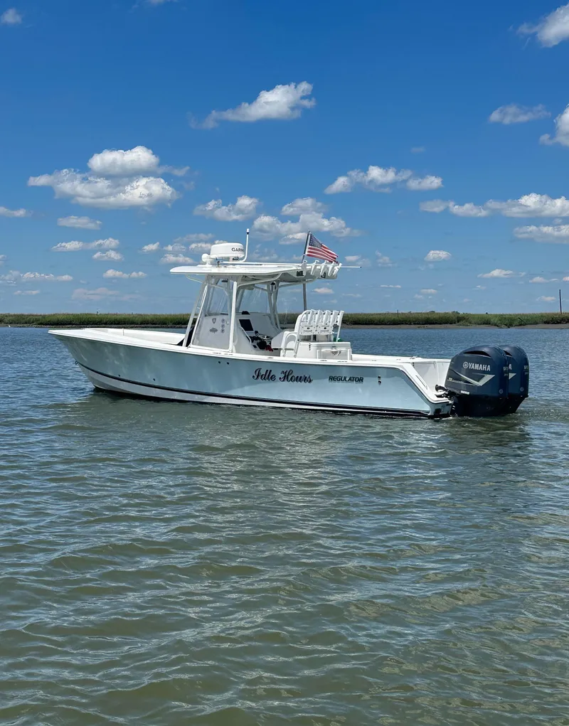 Slide: The Image of 2009 Regulator 32FS boat on water under blue sky with clouds. - 17