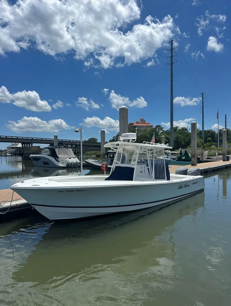 Slide: The Image of 2009 Regulator 32FS boat docked under a clear blue sky. - 4