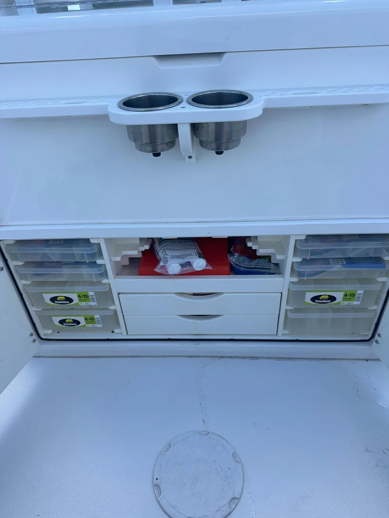 Slide: The Image of 2009 Regulator 32FS boat storage with cup holders and organized compartments. - 9