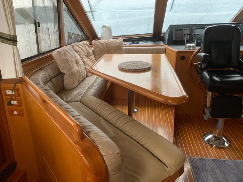 Slide: The Image of Luxurious interior of a 1997 Ocean Alexander 548 yacht with plush seating and helm. - 10