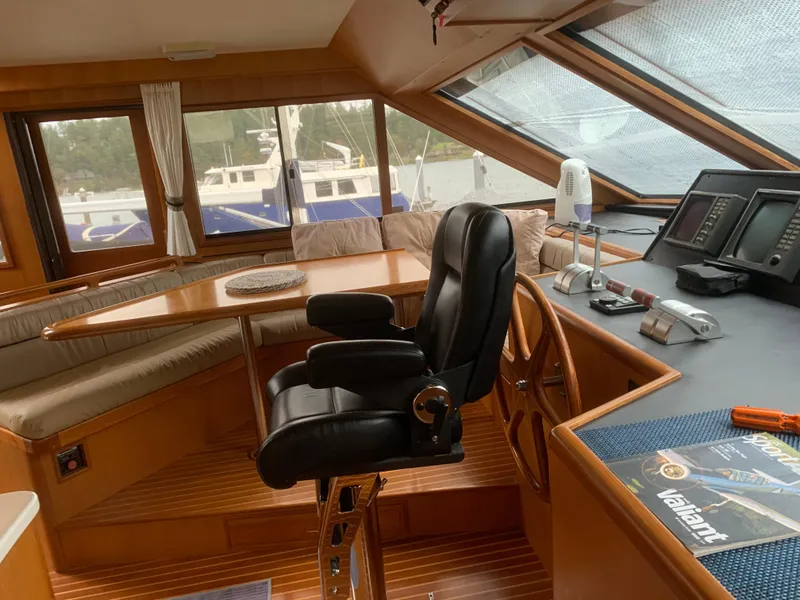 Slide: The Image of Luxurious 1997 Ocean Alexander 548 yacht interior with helm, seating, and navigation equipment. - 11