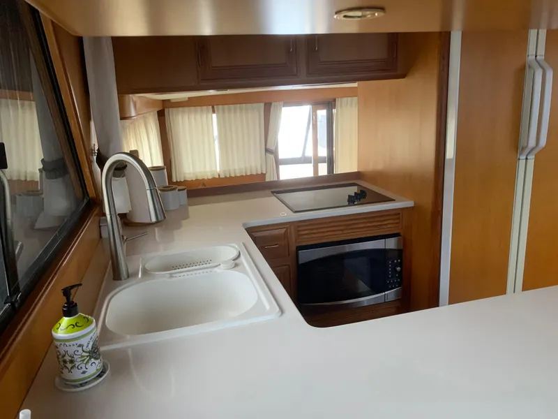Slide: The Image of Interior of 1997 Ocean Alexander 548 yacht kitchen with sink, stove, and microwave. - 14