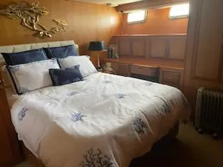 Slide: The Image of Luxurious bedroom in 1997 Ocean Alexander 548 yacht with elegant bedding and wooden cabinetry. - 23