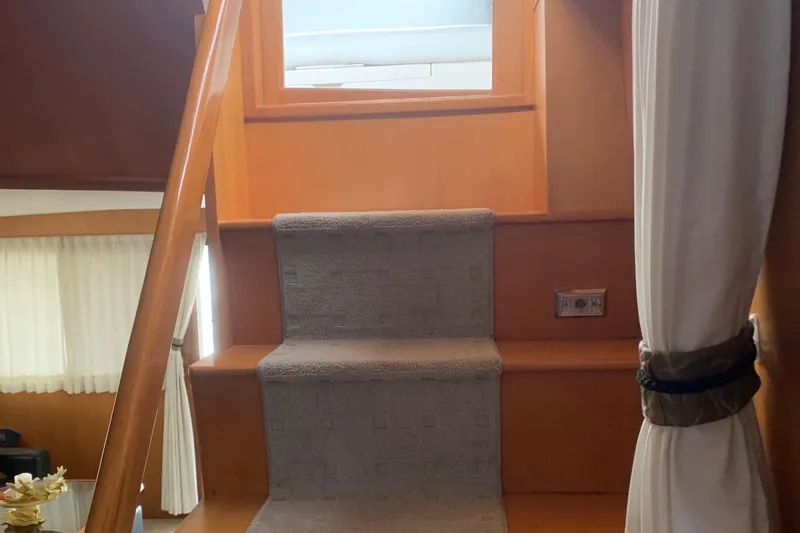 Slide: The Image of Staircase inside 1997 Ocean Alexander 548 yacht with carpet and wooden finish. - 28