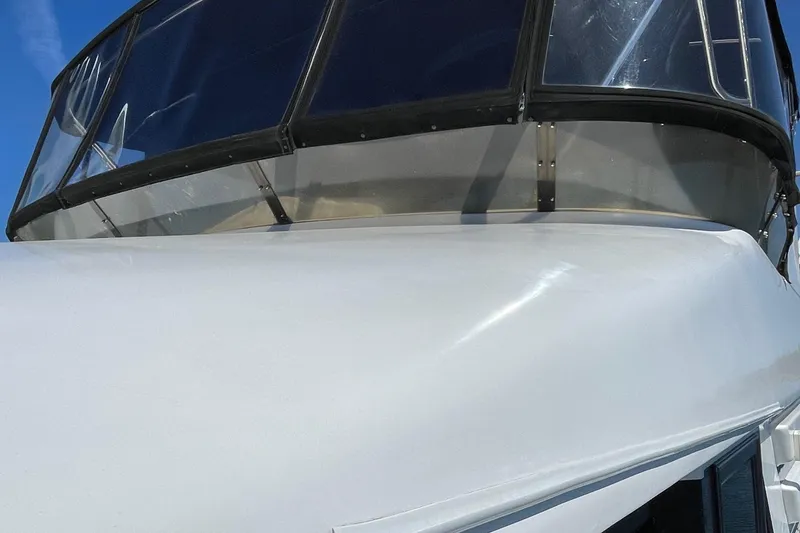 Slide: The Image of Close-up of 1997 Ocean Alexander 548 yacht's sleek white exterior and tinted windows. - 29