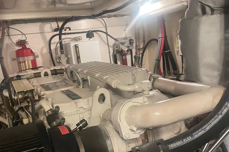 Slide: The Image of Engine room of a 1997 Ocean Alexander 548 yacht, showcasing mechanical components and piping. - 37