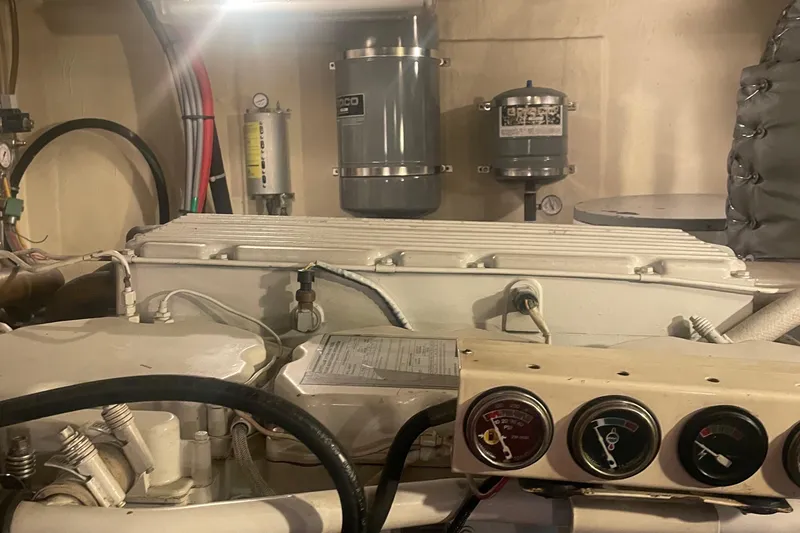 Slide: The Image of Engine room of 1997 Ocean Alexander 548 yacht, featuring gauges and mechanical components. - 38