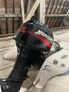Slide: The Image of Mercury 40 outboard motor on a 1997 Ocean Alexander 548 boat in a wooden boathouse. - 39