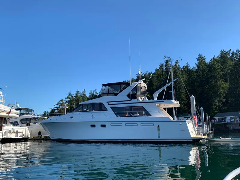 Slide: The Image of 1997 Ocean Alexander 548 yacht docked in a serene marina setting. - 4