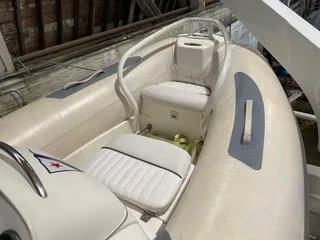 Slide: The Image of 1997 Ocean Alexander 548 yacht interior with white seating and nautical flag detail. - 40