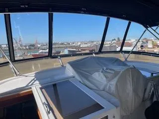 Slide: The Image of Interior view of 1997 Ocean Alexander 548 yacht with covered controls and marina backdrop. - 7