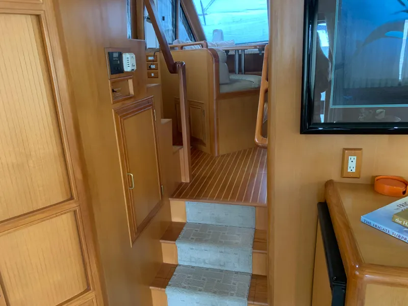 Slide: The Image of Interior of 1997 Ocean Alexander 548 yacht, featuring wooden stairs and cabinetry. - 9