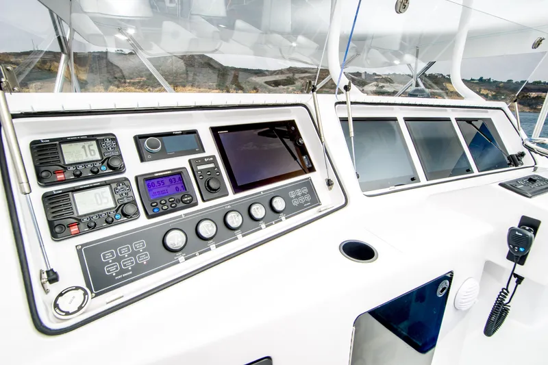 Slide: The Image of Control panel of a 2003 Donzi 65 Convertible yacht, featuring navigation and communication equipment. - 4