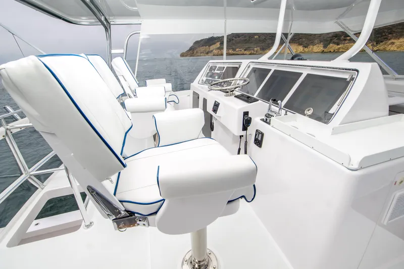 Slide: The Image of 2003 Donzi 65 Convertible yacht helm with white seating and ocean view. - 7