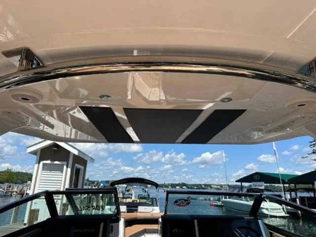 Slide: The Image of 2024 Cobalt R33 Surf boat interior with lake view and clear sky. - 12