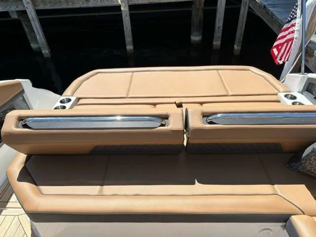 Slide: The Image of 2024 Cobalt R33 Surf boat with tan leather seating and American flag. - 15