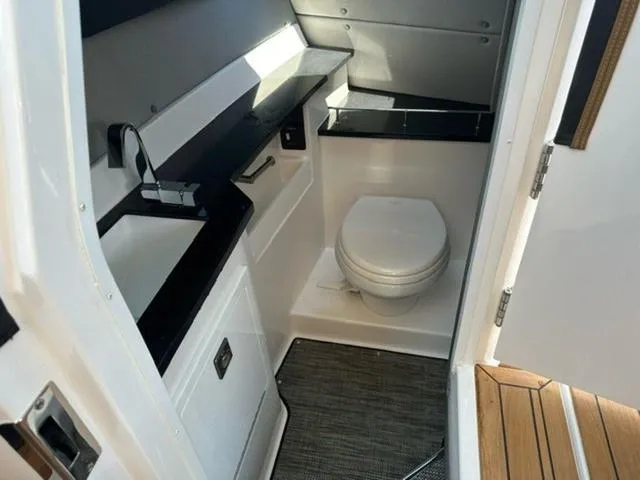 Slide: The Image of 2024 Cobalt R33 Surf boat bathroom with modern fixtures and sleek design. - 4
