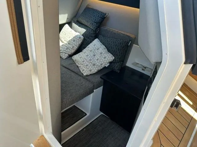 Slide: The Image of 2024 Cobalt R33 Surf cabin interior with cozy seating and cushions. - 5