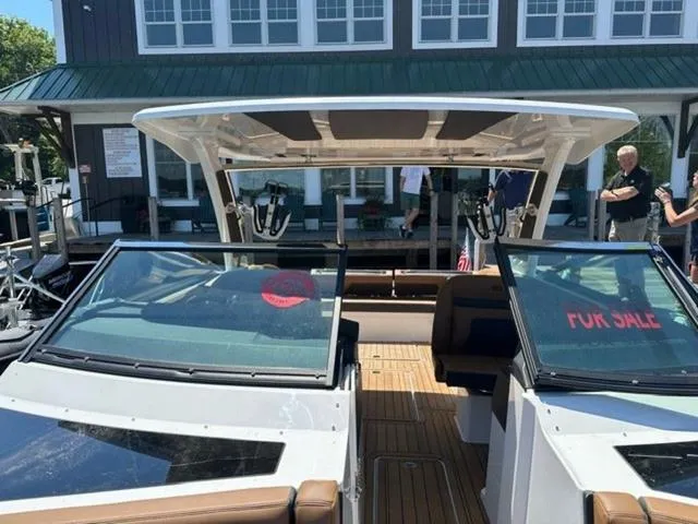 Slide: The Image of 2024 Cobalt R33 Surf boat for sale at a dock, featuring modern design and spacious seating. - 7