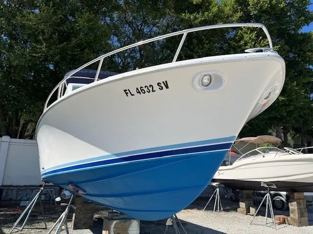Slide: The Image of 1984 Bertram Express Moppie boat on stands, front view. - 38